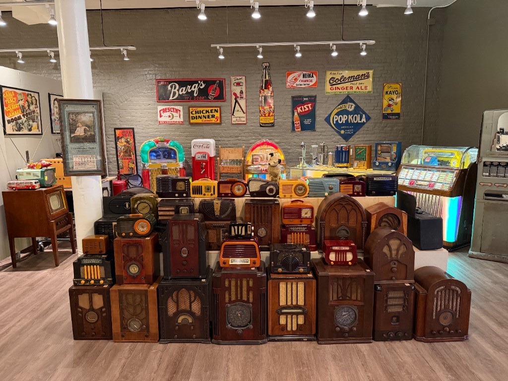 A wall of old radios stacked in the gallery